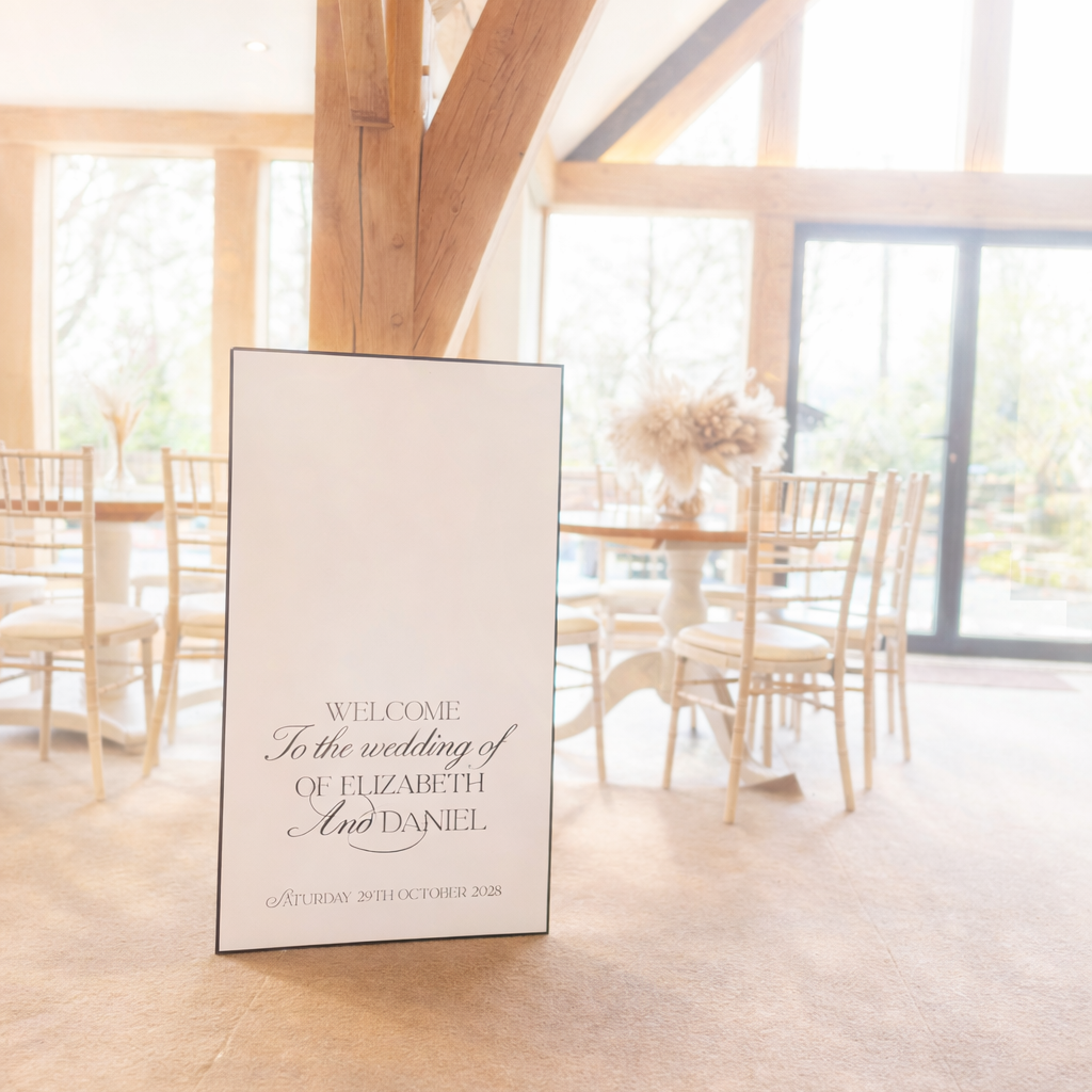 a wedding reception setting with a sign welcoming guests to the wedding of Elizabeth and Daniel.