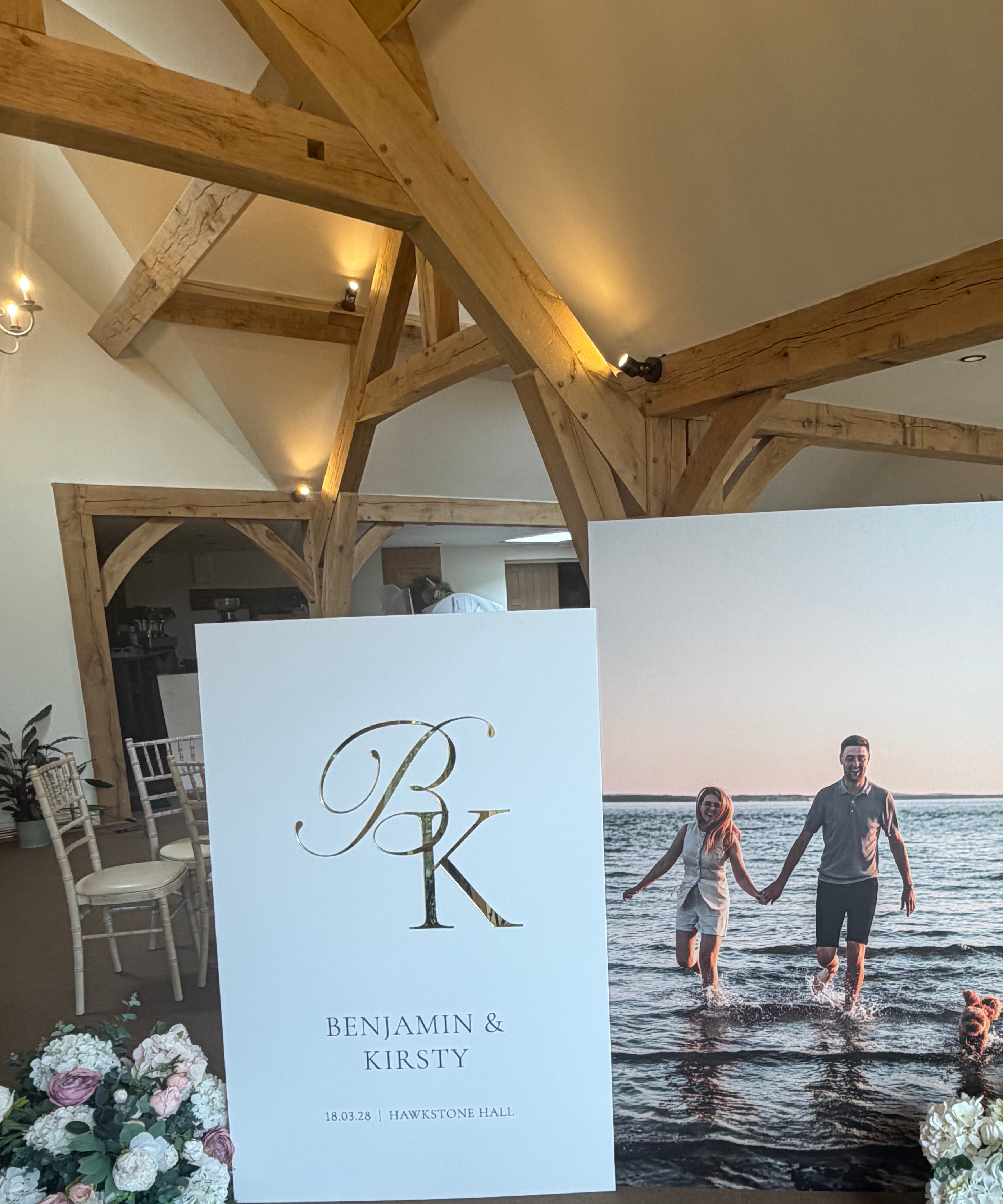 a wedding invitation with a couple standing in front of a large photograph of the couple.