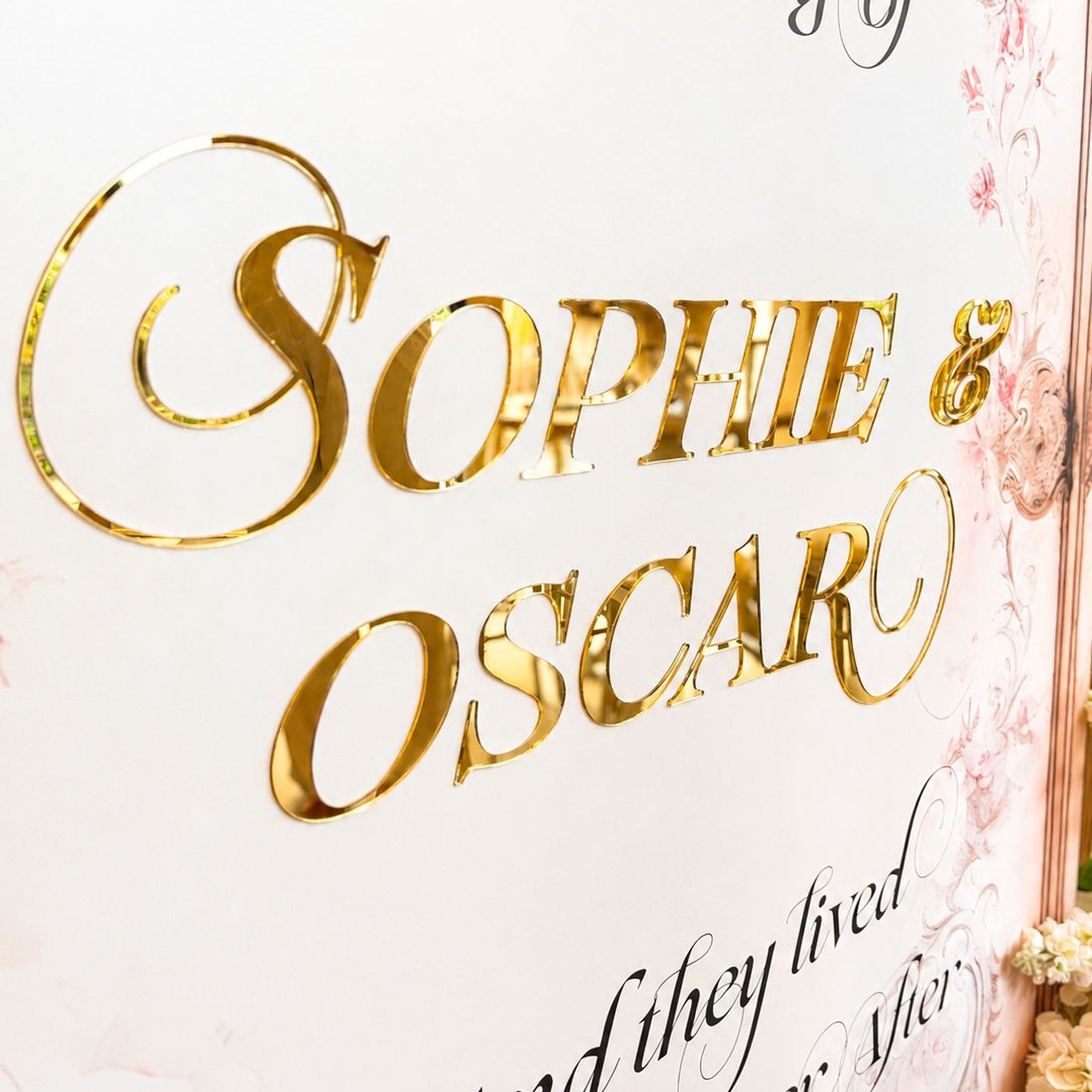 a close-up of a sign with the names "Sophie & Oscar" written in a decorative font.