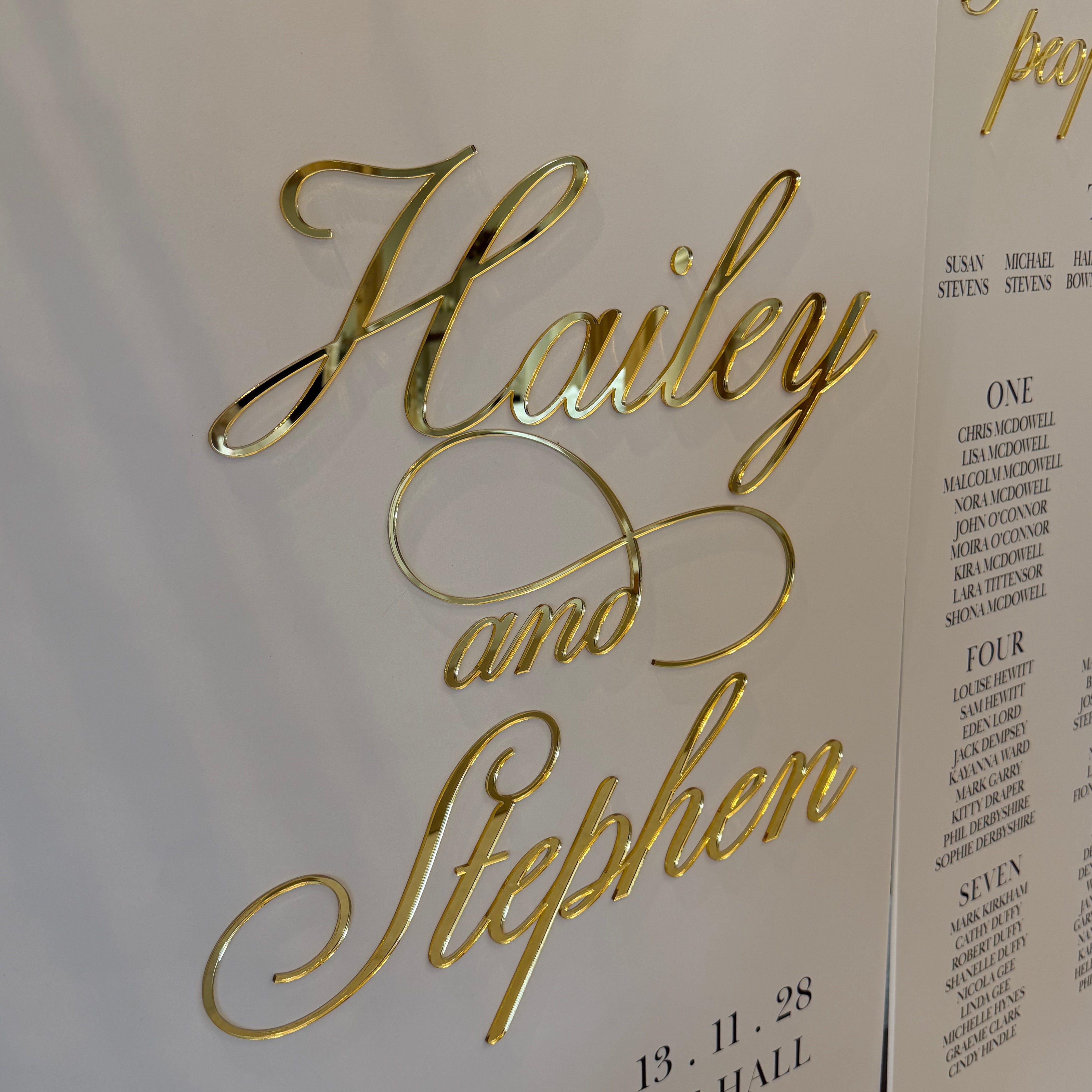 a close-up of a decorative gold text that reads "Haley and Stephen" on a white background.