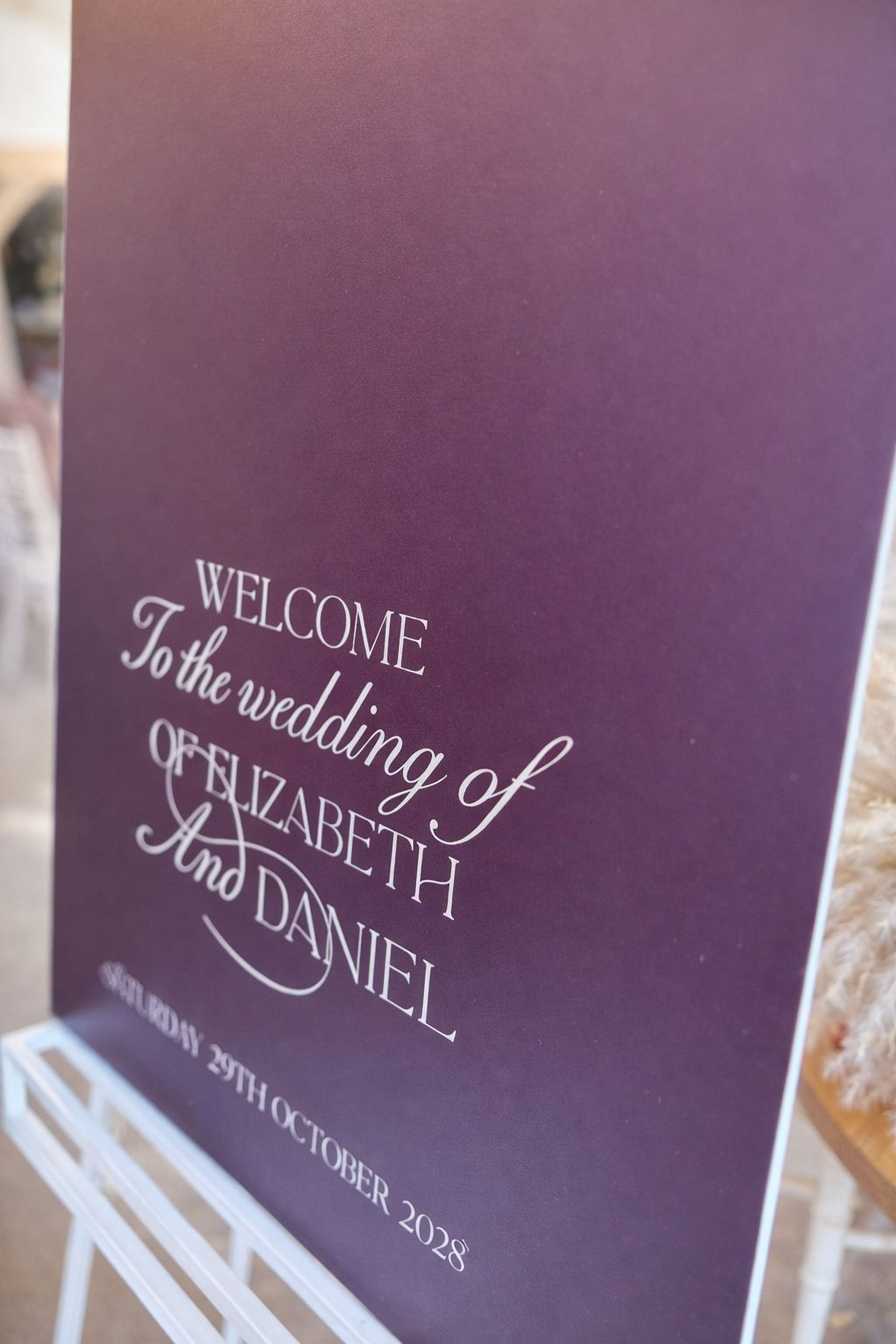a purple sign welcoming guests to the wedding of Elizabeth and Daniel.