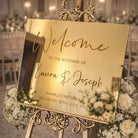 a wedding invitation sign with the text "Welcome to the Wedding of Laura & Joseph" and "HAWKSTONE HALL SATURDAY 18TH JULY 2025".