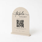 a beige table sign with a QR code and text, including a QR code and text that reads "Table Eight" and "Scan here to upload".