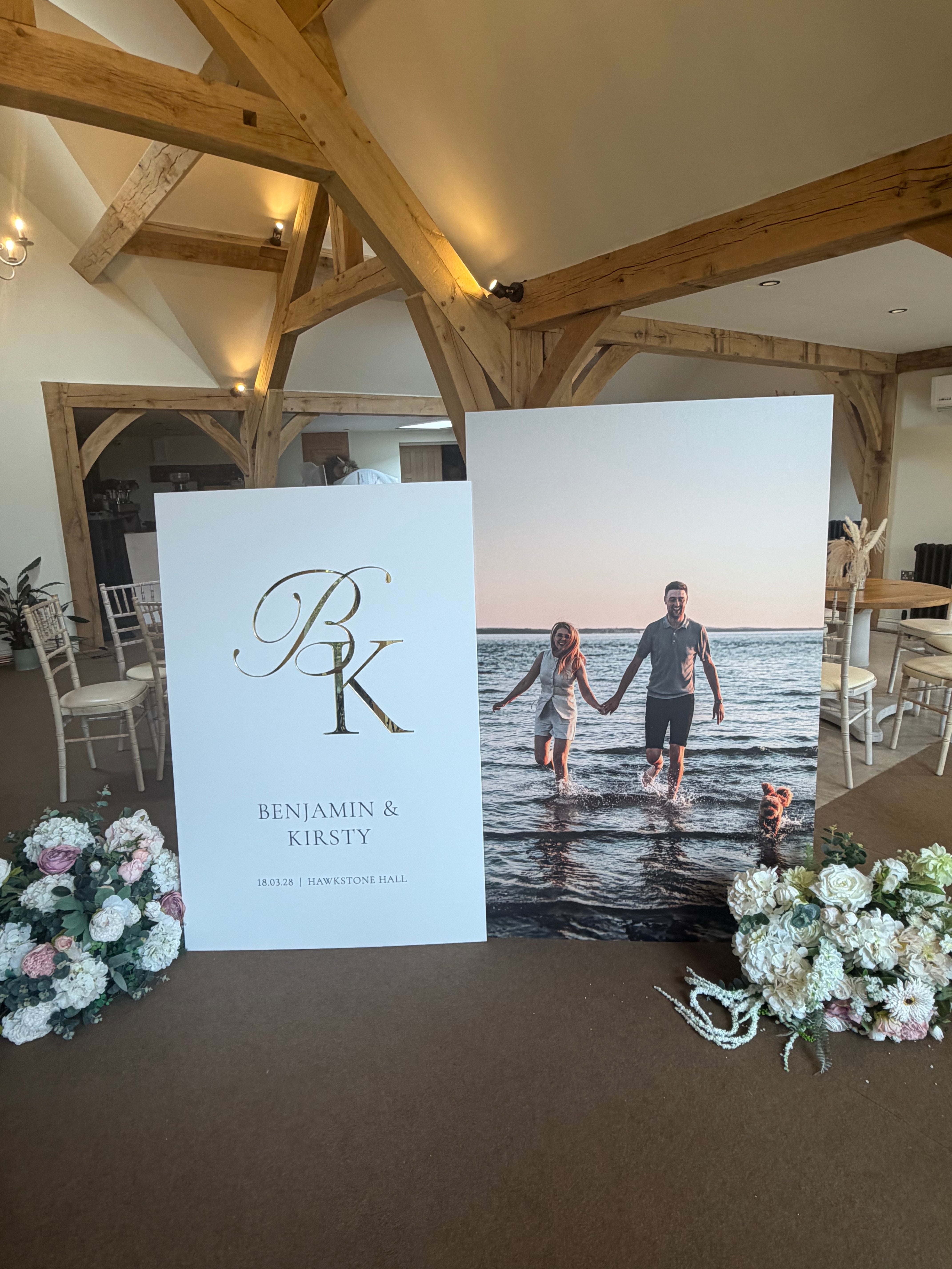 a wedding invitation with a couple standing in front of a large photograph of the couple.
