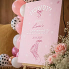 A pink sign with white text welcoming guests to a "Last Rodeo" event on August 20, 2017.