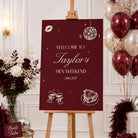 a red sign welcoming guests to Taylor's Hen Weekend, surrounded by festive decorations such as balloons, flowers, and a bride to be sign.