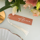 a table setting with a name tag, a plate, and a bouquet of flowers.