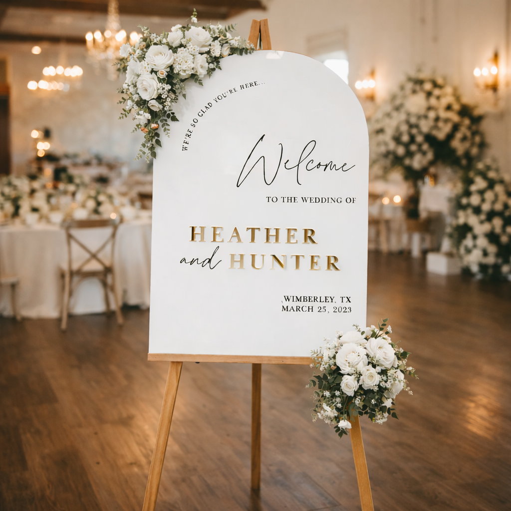 A white sign with gold lettering welcoming guests to the wedding of Heather and Hunter, located in Wimberley, Texas on March 25, 2023.