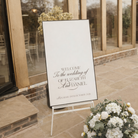 a white sign welcoming guests to the wedding of Elizabeth and Daniel.