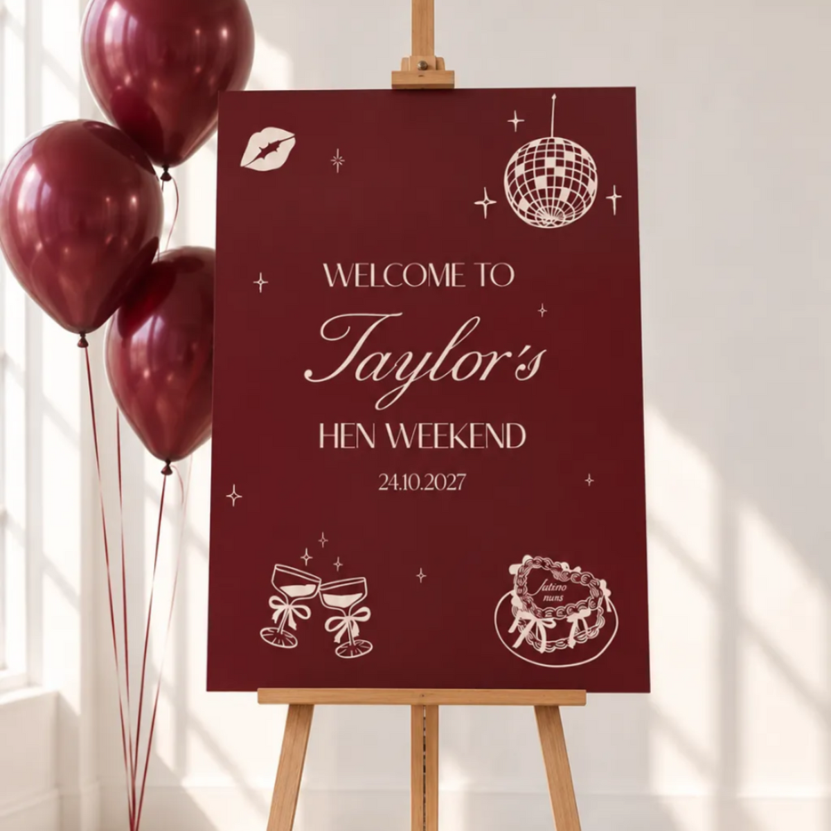 A red sign welcoming guests to Taylor's Hen Weekend, with balloons and a disco ball in the background.
