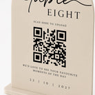 The image is a sign with a QR code and text that appears to be a promotional message or announcement.