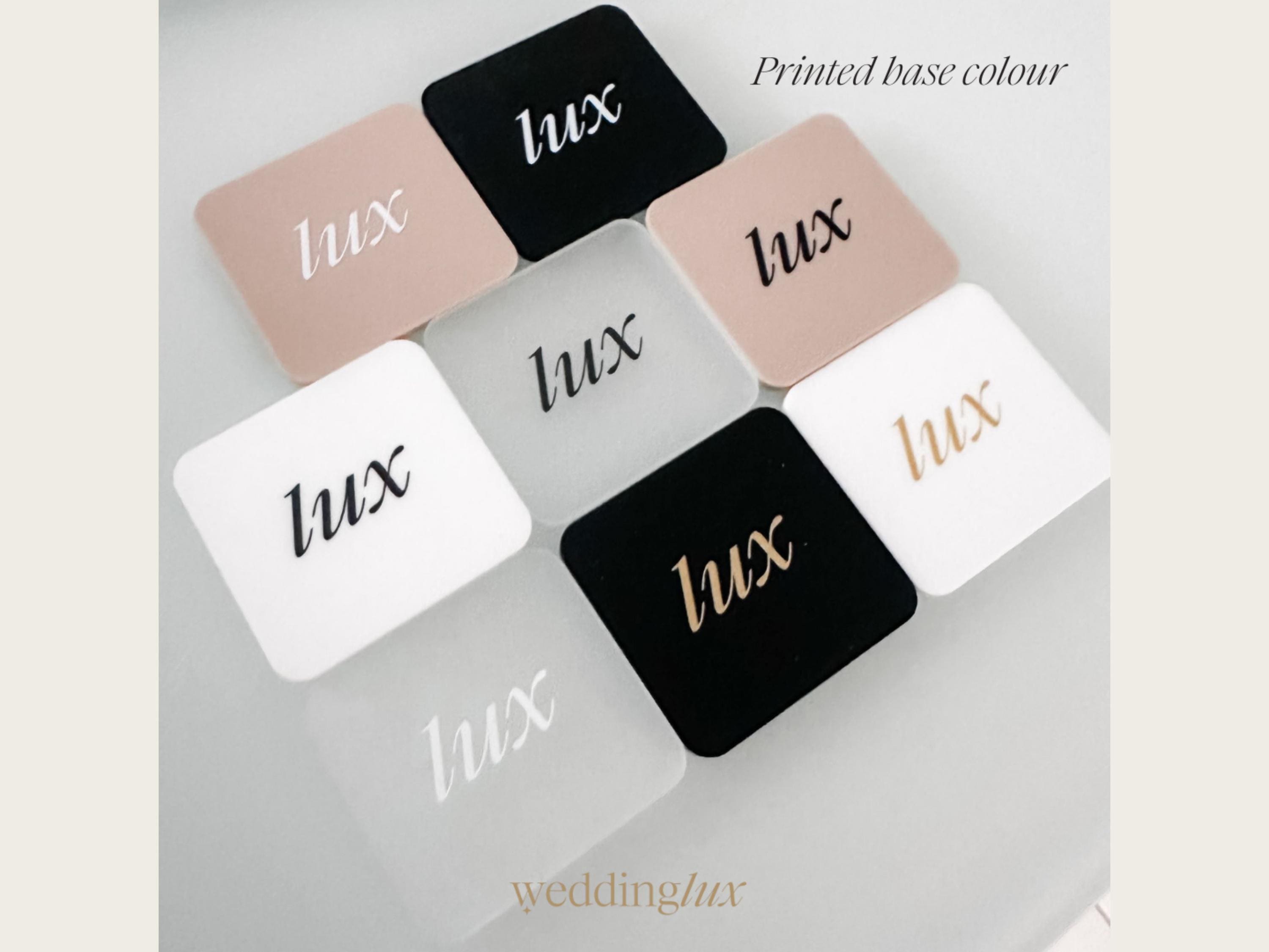 A collection of square-shaped objects with the word "Lux" printed on them, arranged in a grid-like pattern.