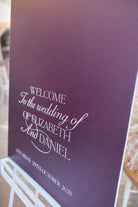 a purple sign welcoming guests to the wedding of Elizabeth and Daniel.