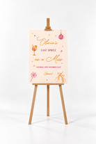 The image is a poster or sign with text and illustrations, standing on a wooden easel.