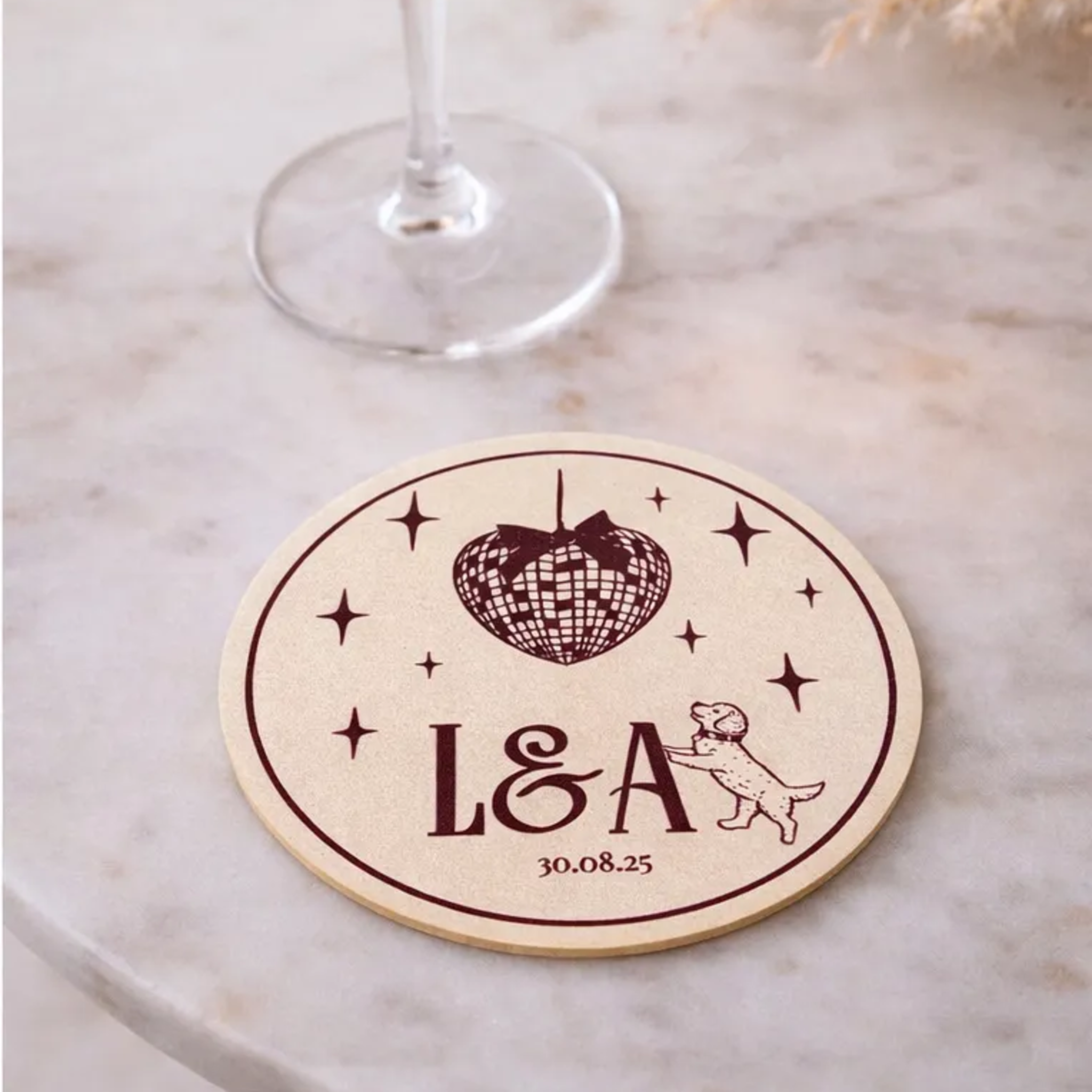 a round coaster with a design of a disco ball and stars, along with the text "L&A" and a date "30.08.25".