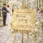 a golden wedding sign welcoming guests to a wedding ceremony.